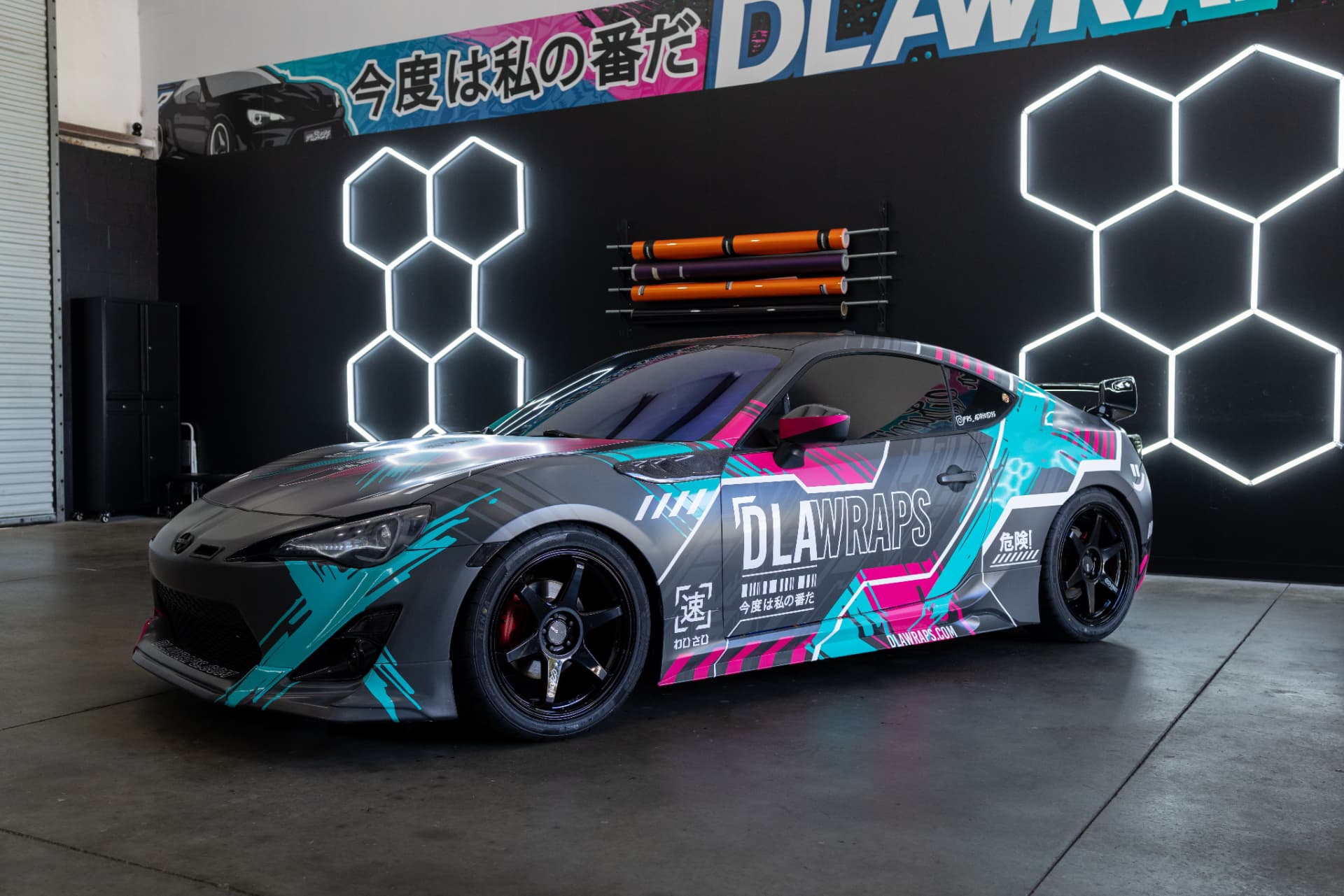 Sports coupe with turquoise and pink graphic wrap